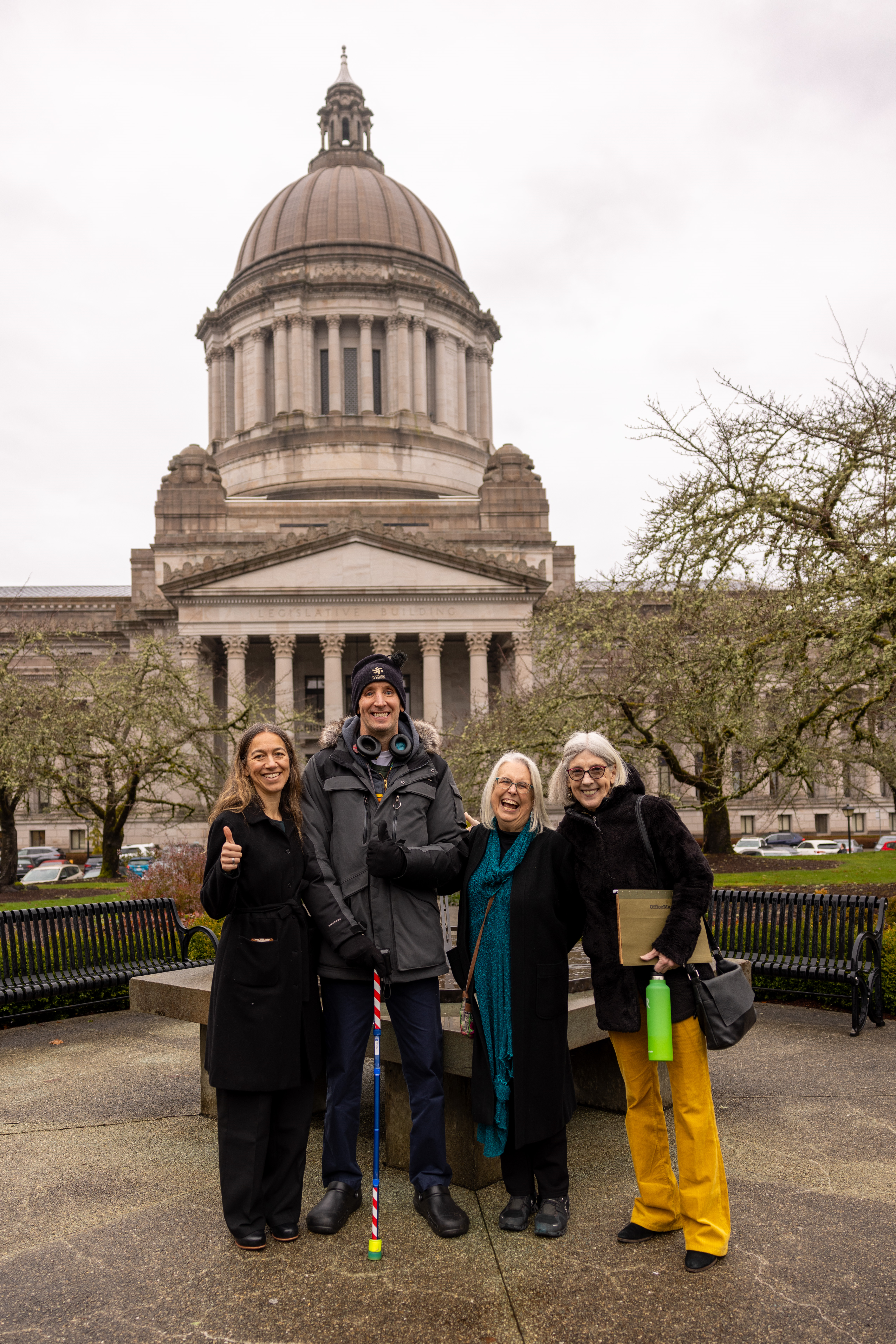 People and family members living with brain injury smiling in front of the Olympia capitol building.